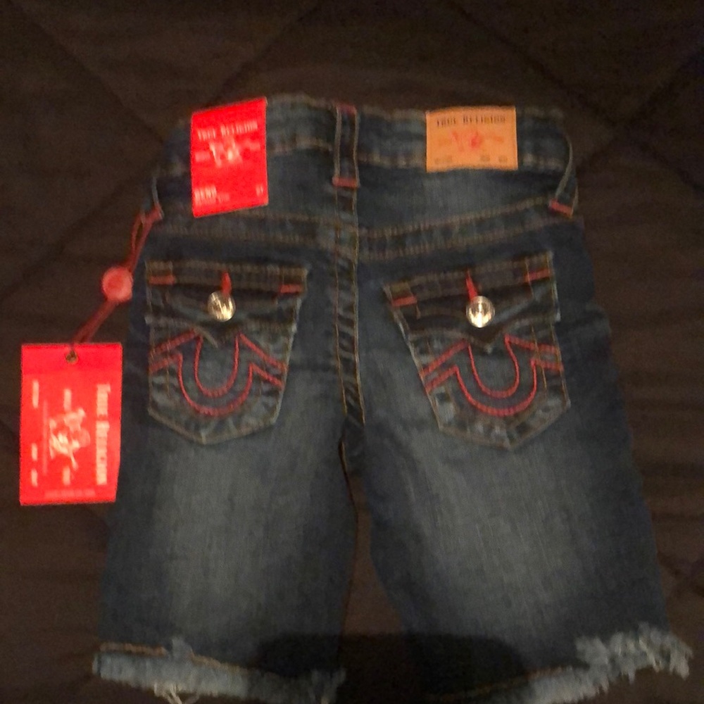 True Religion dark blue Bermuda short with red stiching.
